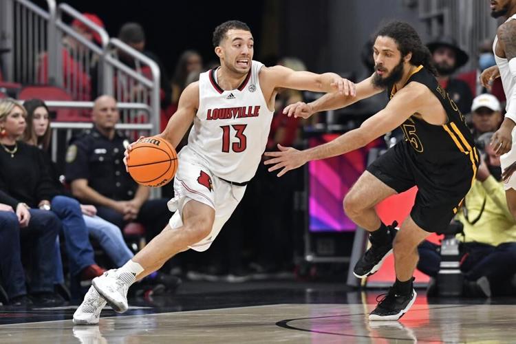 Louisville guard Jarrod West drives around Southeastern Louisiana guard Joe Kasperzyk.jpeg