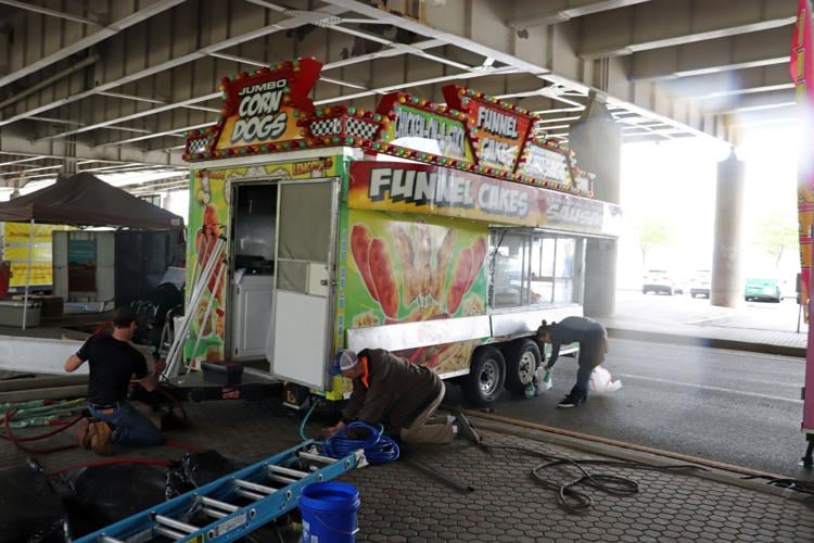 Crews set up booths along the Ohio River one day before Thunder Over Louisville 2023