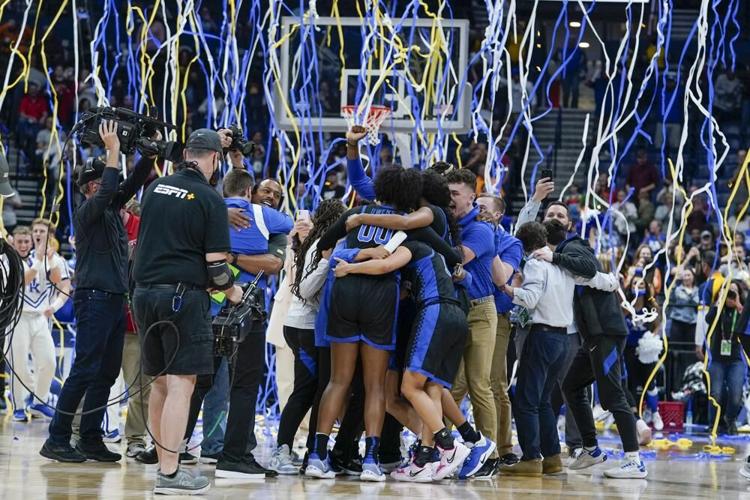 Kentucky players celebrate after beating South Carolina in the SEC tournament championship.jpeg