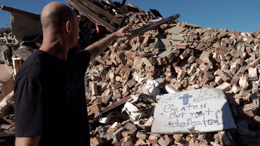 Brian Brooks near candle factory rubble