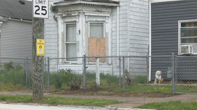 Home in Louisville's Portland neighborhood with boarded up window