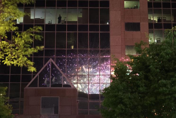 Man watching fireworks from building on Main Street
