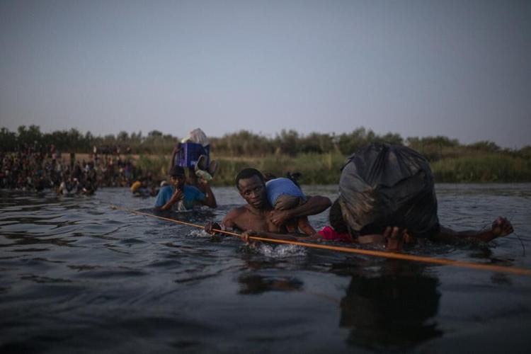 Migrants from Haiti cross Rio Grande