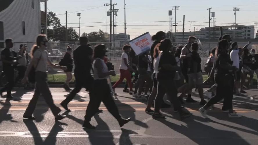 Protesters march past Churchill Downs on Derby day