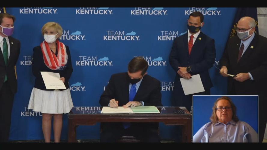 Kentucky Gov. Andy Beshear signs bi-partisan election reform bill on April 7, 2021