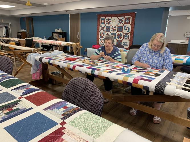 Women from the St. Joseph Ladies Sewing Society sew quilts for the St. Joseph Children's Home