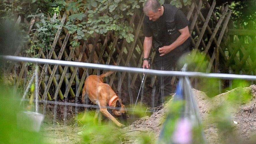 German police officers search property