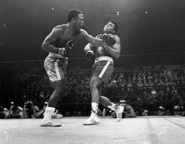 Frazier hits Ali during the 15th round heavyweight fight