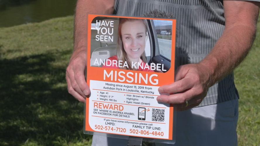 Andrea Knabel's father holds a missing persons flyer as the search for his daughter continues