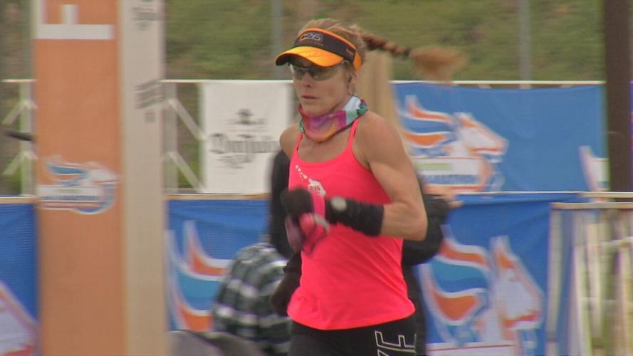 A runner crosses the finish line in the Humana Kentucky Derby Festival Marathon 4/24/21