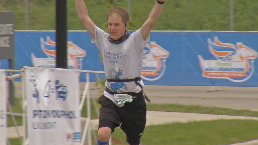 A runner crosses the finish line in the Humana Kentucky Derby Festival Marathon  4/24/21
