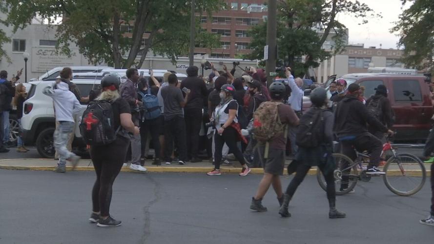 Protesters gather in a parking lot in downtown Louisville 9/24/20
