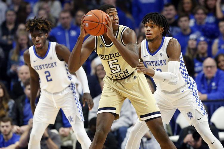 Georgia Tech's Moses Wright, center, looks for an opening on Kentucky's Keion Brooks Jr.
