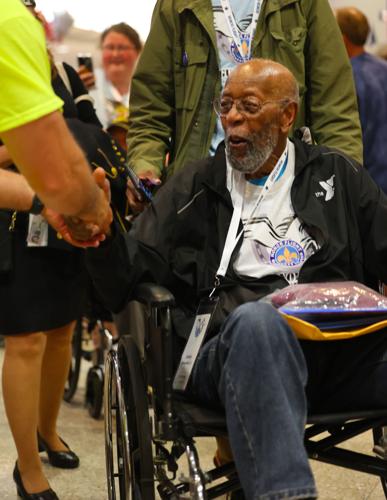 Veteran shakes hand during Honor Flight Return Home procession.JPG
