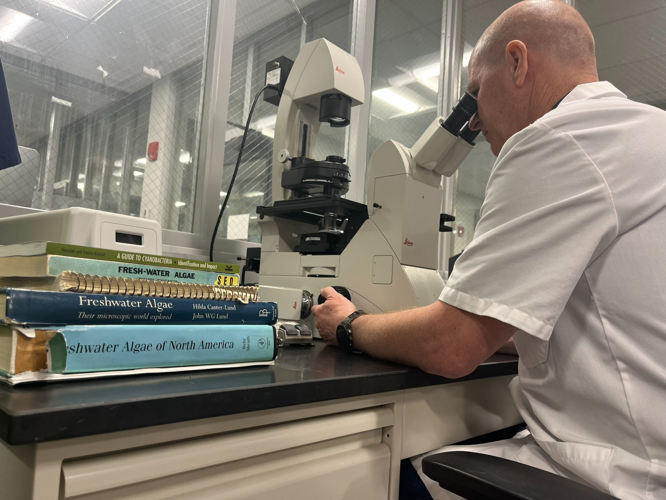 Louisville Water employee tests samples from Ohio River
