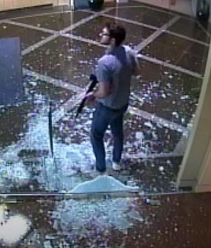 Connor Sturgeon on surveillance video with rifle near shattered glass