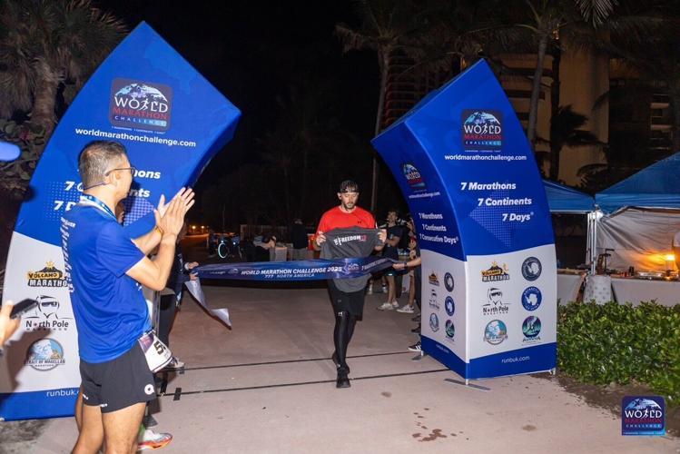 Corey Burton crosses finish line in Miami.jpg