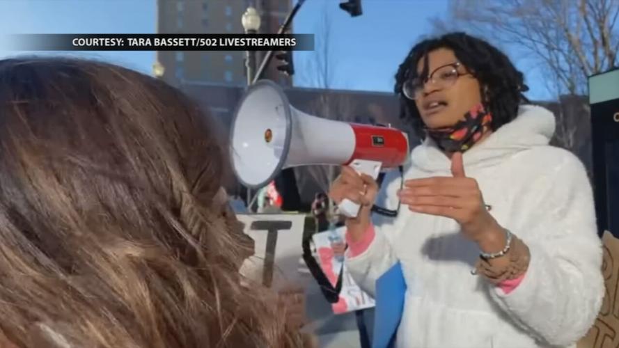 Carmen M. Jones, right, talks with a woman at a protest