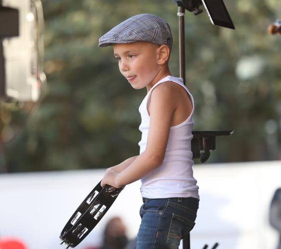 Boy plays the tambourine at Chili Cookoff