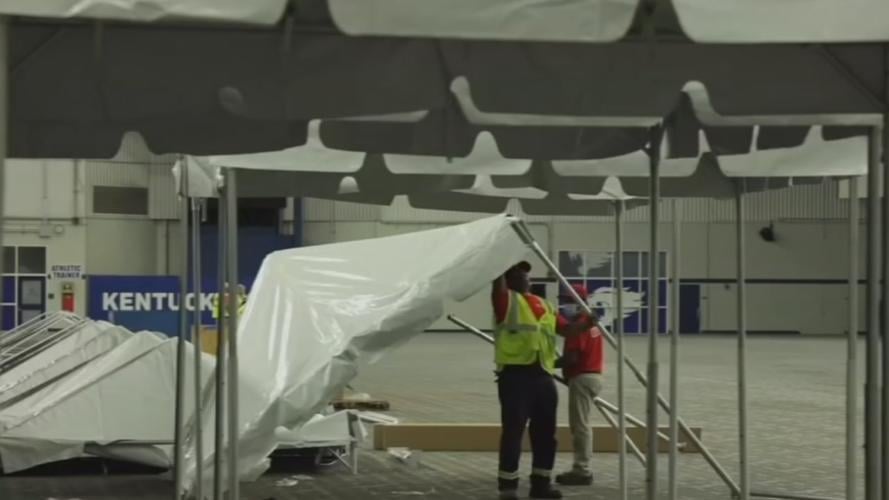 UK COVID-19 field hospital workers setting up tents.jpg