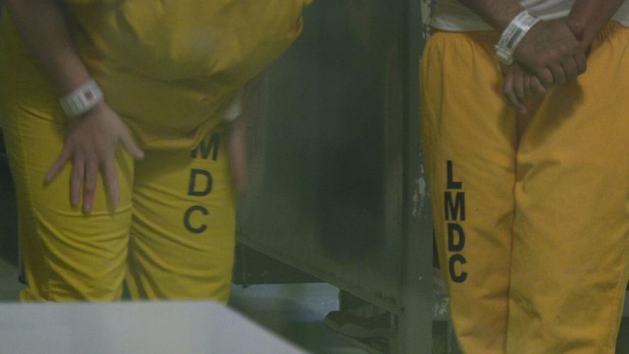 Women inmates in yellow jumpsuits