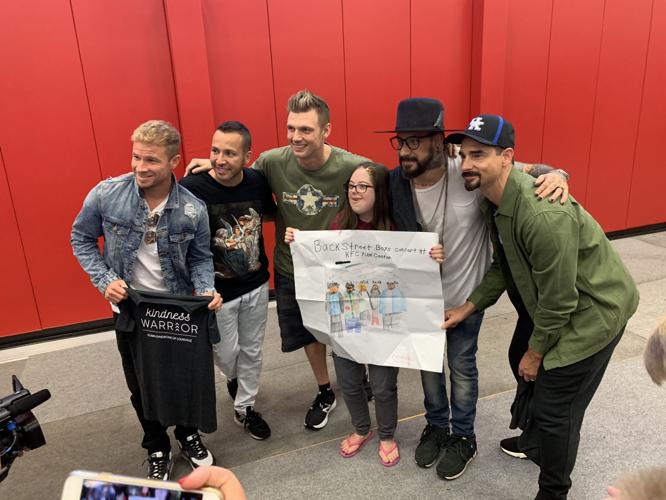 The Backstreet Boys pose with a member of Down Syndrome of Louisville