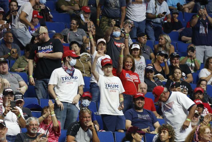 People wait for President Donald Trump to appear at the BOK Center