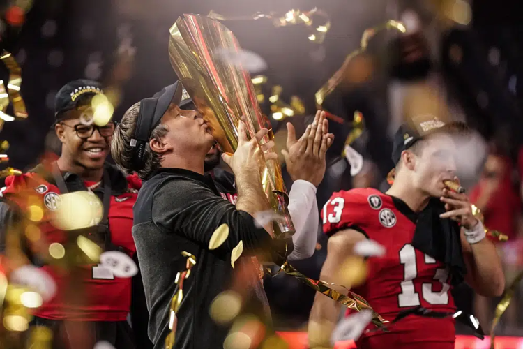 Georgia head coach kisses championship trophy