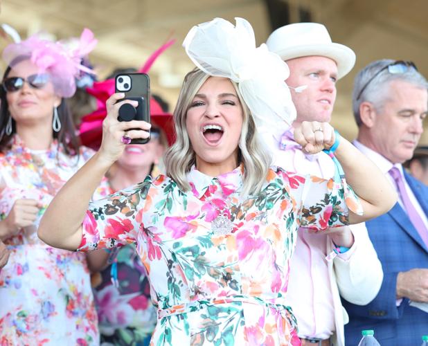 Woman cheers for horses during race.JPG
