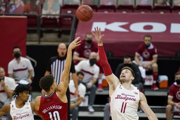 Louisville's Samuell Williamson (10) shoots over Wisconsin's Micah Potter