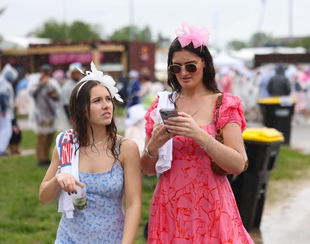 Two people text on phones in infield.JPG