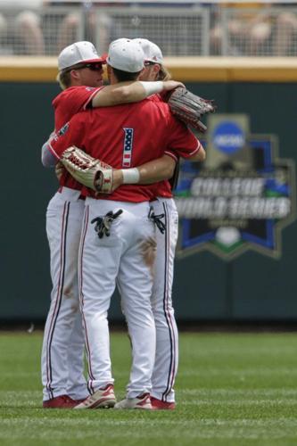 Louisville outfielders including Drew Campbell (1) hug in the outfield