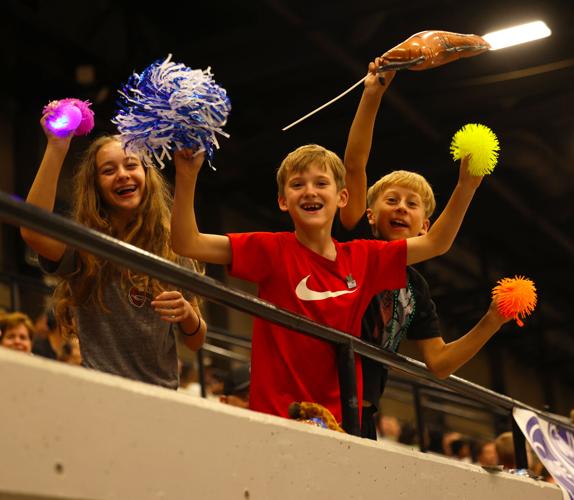 Kids wave to camera in Bed Races.JPG