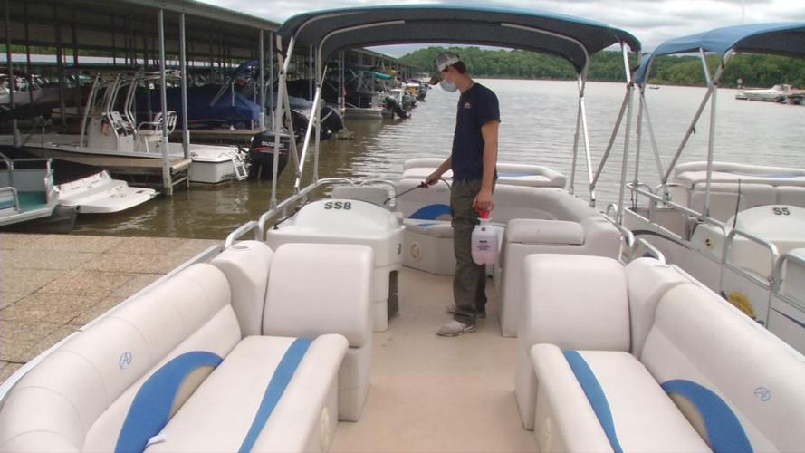 Taylorsville Lake Marina worker sanitizes boat