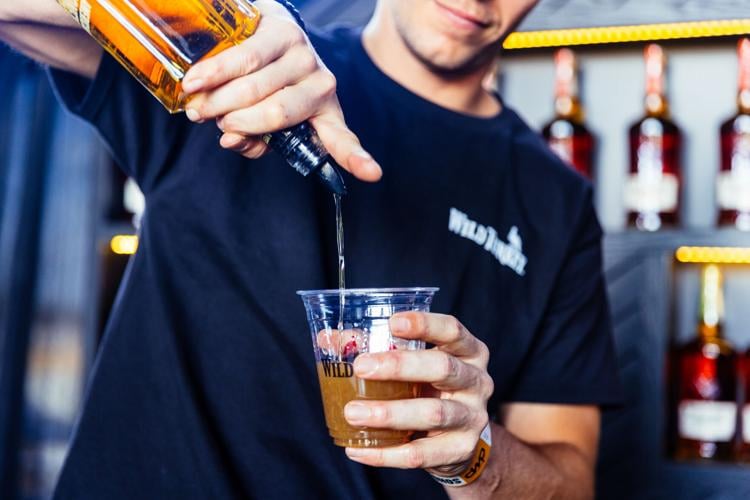 Bartender pours a drink at Bourbon & Beyond at Kentucky Expo Center