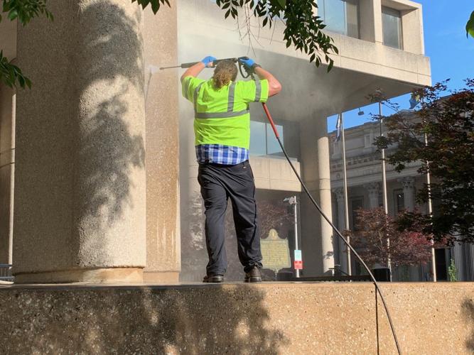 LMPD Protests - Worker cleans graffiti at Hall of Justice