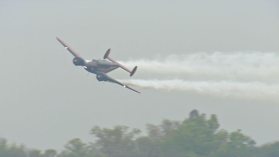 A plane flies over Bowman Field during Thunder Over Louisville airshow 2021