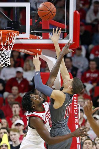 North Carolina State's DJ Funderburk (0) attempts to block the shot of Louisville's Samuell Williamson