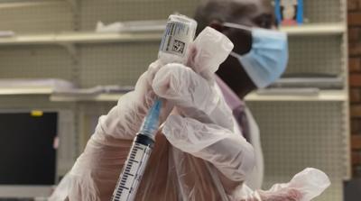 FILE- COVID-19 vaccine shot