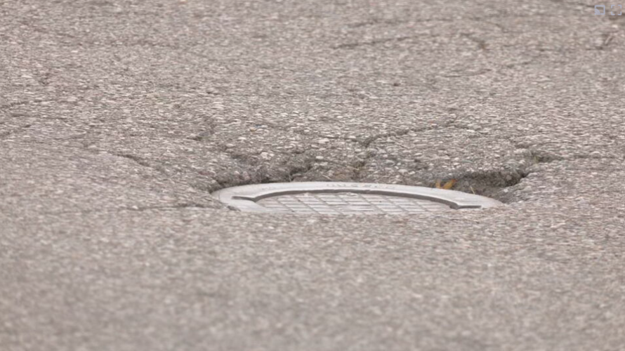 Exposed metal plate on N 20th St in Louisville surrounded by potholes and cracks Thursday, October 14, 2021.PNG