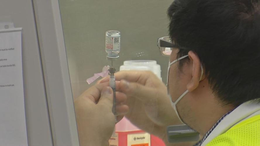 Medical worker with COVID vaccine in vial