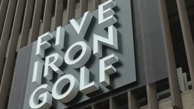 Five Iron Golf sign in downtown Louisville