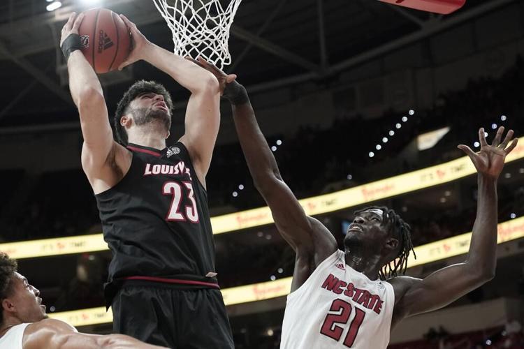 Louisville Center Gabe Wiznitzer shoots while North Carolina State defends.jpeg