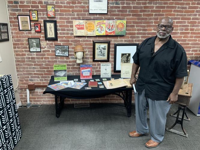 Lamont Collins shows off artifacts from Roots 101 African American History Museum