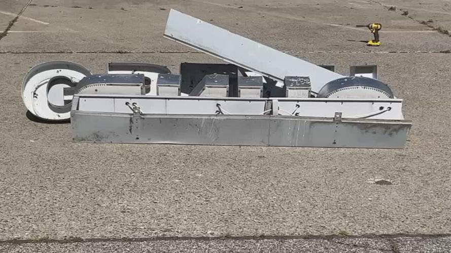 Crews removing sign from former site of Greyhound bus station in downtown Louisville