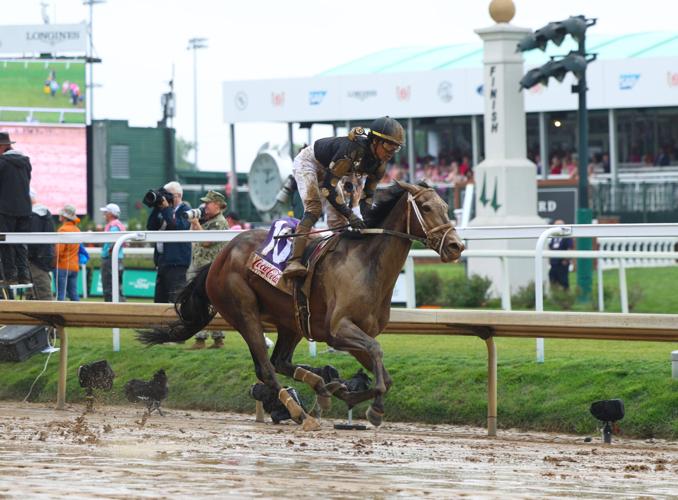 Horse crosses finish line at Churchill mud.JPG