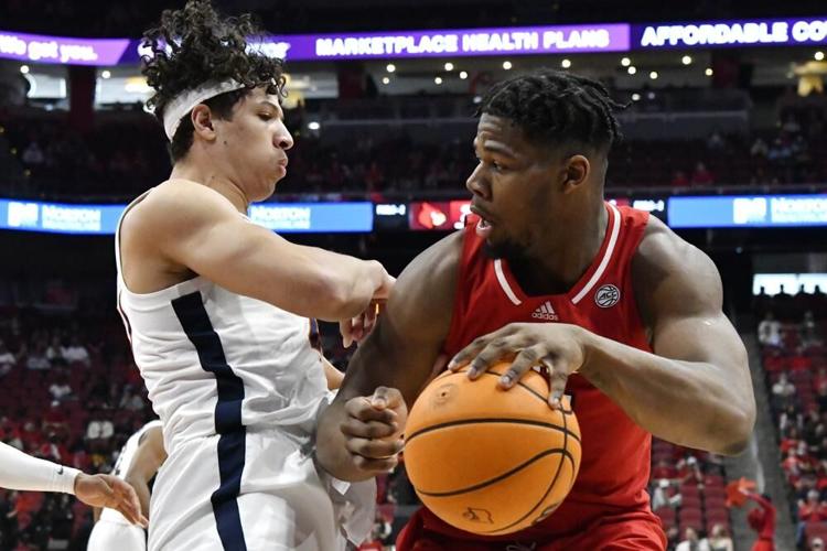Louisville forward Sydney Curry tries to get psat Virginia forward Kadin Shedrick.jpeg
