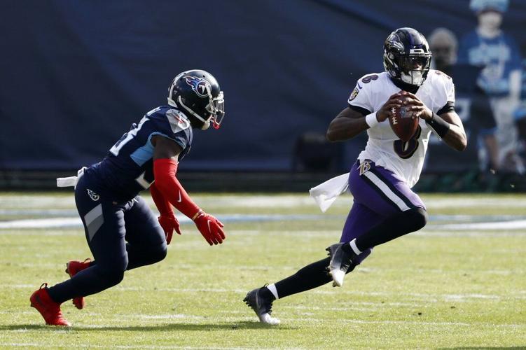 Baltimore Ravens quarterback Lamar Jackson (8) scrambles