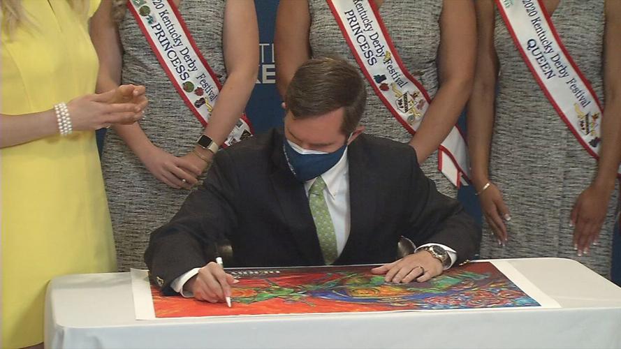 Gov. Andy Beshear signs the official poster of Kentucky Derby 147