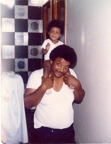 Charles Adams with daughter on shoulders